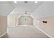 Large bonus room with a neutral color palette, carpet, and an arched window for natural light at 1315 Cherry Dr., Surfside Beach, SC 29575