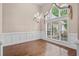 Open dining area featuring a chandelier, wainscotting, and large windows at 1315 Cherry Dr., Surfside Beach, SC 29575