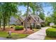 Charming brick home with mature landscaping, a paved driveway, and a well-manicured front lawn at 1315 Cherry Dr., Surfside Beach, SC 29575