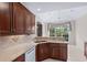 Bright kitchen with tile flooring, wood cabinets and a view of the backyard at 1315 Cherry Dr., Surfside Beach, SC 29575