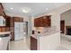Well-lit kitchen featuring wood cabinets, modern appliances, and a beige countertop at 1315 Cherry Dr., Surfside Beach, SC 29575