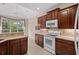Bright kitchen with wood cabinets, tile backsplash, and white appliances at 1315 Cherry Dr., Surfside Beach, SC 29575