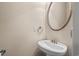 Elegant powder room features a stylish, decorative oval mirror and pedestal sink at 1315 Cherry Dr., Surfside Beach, SC 29575