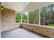 Screened porch with brick walls and a view of the backyard pond at 1315 Cherry Dr., Surfside Beach, SC 29575