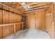Interior view of a shed with exposed wood framing and shelving for organized storage at 1315 Cherry Dr., Surfside Beach, SC 29575