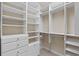 Organized walk-in closet with shelving, drawers, and hanging rods for ample storage at 1315 Cherry Dr., Surfside Beach, SC 29575