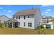 Back exterior featuring screened in patio and a manicured lawn at 1325 Bermuda Grass Dr., Myrtle Beach, SC 29579