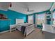 Bright bedroom with blue accent wall, ceiling fan, and windows with natural light at 1325 Bermuda Grass Dr., Myrtle Beach, SC 29579