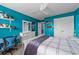 Bedroom featuring blue accent wall, fan, plush carpet, and desk space at 1325 Bermuda Grass Dr., Myrtle Beach, SC 29579