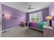This bedroom has an accent wall, desk and chair, and fan at 1325 Bermuda Grass Dr., Myrtle Beach, SC 29579