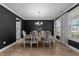 Elegant dining room with dark accent wall, wood floors, chandelier and bright windows at 1325 Bermuda Grass Dr., Myrtle Beach, SC 29579