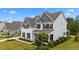 Two-story home featuring a welcoming exterior with blue accents, black shutters, and a well-maintained lawn at 1325 Bermuda Grass Dr., Myrtle Beach, SC 29579