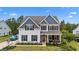 Charming two-story home with a brick entryway, covered porch, and manicured landscaping at 1325 Bermuda Grass Dr., Myrtle Beach, SC 29579