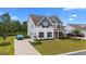 Exterior view of home showcasing manicured landscaping and a long driveway at 1325 Bermuda Grass Dr., Myrtle Beach, SC 29579