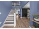 Bright foyer with hardwood floors, staircase, and views into the living room and kitchen at 1325 Bermuda Grass Dr., Myrtle Beach, SC 29579