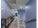 Hallway with blue accent walls, console table, and hardwood steps at 1325 Bermuda Grass Dr., Myrtle Beach, SC 29579