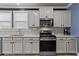Close up of the kitchen with modern appliances and cabinetry, complemented by a stylish backsplash at 1325 Bermuda Grass Dr., Myrtle Beach, SC 29579