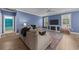 Cozy living room with neutral decor, ceiling fan, fireplace, and lots of natural light at 1325 Bermuda Grass Dr., Myrtle Beach, SC 29579