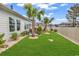 Beautifully landscaped backyard featuring palm trees, an outdoor patio, and lush green grass at 1340 Jolly Roger Dr., North Myrtle Beach, SC 29582