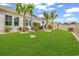 Spacious backyard with palm trees, a cozy outdoor patio, and manicured landscaping at 1340 Jolly Roger Dr., North Myrtle Beach, SC 29582