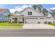 Charming white home with a three-car garage and inviting front porch, set in a well-maintained community at 1340 Jolly Roger Dr., North Myrtle Beach, SC 29582