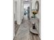 Bright hallway featuring hardwood floors, an elegant accent table, and a glimpse into the living area at 1340 Jolly Roger Dr., North Myrtle Beach, SC 29582