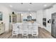 Stylish kitchen with a large island, stainless steel appliances, and adjacent dining area with barstool seating at 1340 Jolly Roger Dr., North Myrtle Beach, SC 29582