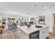 Open-concept living space with a kitchen island, dining area, and cozy living room featuring a fireplace at 1340 Jolly Roger Dr., North Myrtle Beach, SC 29582