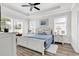 Serene main bedroom with tray ceiling, large windows, and wood-look floors, offering a peaceful retreat at 1340 Jolly Roger Dr., North Myrtle Beach, SC 29582