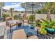 Relaxing outdoor patio with comfortable seating, tropical plants, and a stylish blue rug at 1340 Jolly Roger Dr., North Myrtle Beach, SC 29582