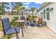 Outdoor patio features a cozy seating area, tropical landscaping, and an umbrella for shade at 1340 Jolly Roger Dr., North Myrtle Beach, SC 29582