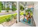 Inviting front porch with rocking chairs and decorative peacock statues amidst lush landscaping and stone accents at 1340 Jolly Roger Dr., North Myrtle Beach, SC 29582