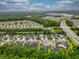 An aerial community view showing homes alongside major roadways and nearby ponds surrounded by lush trees at 1444 Thames Ct., Myrtle Beach, SC 29577