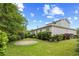 Well-maintained backyard featuring a circular brick patio area, lush green grass, and manicured hedges at 1444 Thames Ct., Myrtle Beach, SC 29577