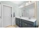 Bathroom with double sink vanity, linen closet, and decorative leaf wall art at 1444 Thames Ct., Myrtle Beach, SC 29577