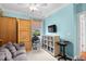 Bright bedroom featuring light-blue painted walls, carpeted floors, a ceiling fan and a large window for natural light at 1444 Thames Ct., Myrtle Beach, SC 29577