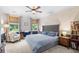 Cozy bedroom features a plush bed, natural light, and elegant crown molding at 1444 Thames Ct., Myrtle Beach, SC 29577
