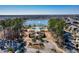 Aerial view of a community pool area with palm trees, a pond with fountain, and a nearby cabana at 1444 Thames Ct., Myrtle Beach, SC 29577