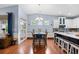 Dining area adjacent to the kitchen features a stylish table, hardwood floors, and natural light at 1444 Thames Ct., Myrtle Beach, SC 29577