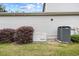 Exterior view of a home's side with a generator and air conditioning unit surrounded by well maintained landscaping at 1444 Thames Ct., Myrtle Beach, SC 29577