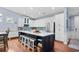 Bright and modern kitchen with a large island, bar seating, stainless steel appliances, and white cabinetry at 1444 Thames Ct., Myrtle Beach, SC 29577