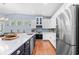 Bright kitchen with a large island, stainless steel appliances, white cabinets, and a mosaic backsplash at 1444 Thames Ct., Myrtle Beach, SC 29577
