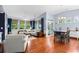 Bright living room featuring a dining table, comfortable seating, and hardwood flooring throughout at 1444 Thames Ct., Myrtle Beach, SC 29577