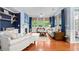 Spacious living room with hardwood floors, stylish furnishings, fireplace, and views of the lush backyard at 1444 Thames Ct., Myrtle Beach, SC 29577