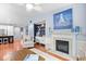 Open-concept living room featuring a fireplace, custom built-ins, hardwood floors, and bright decor at 1444 Thames Ct., Myrtle Beach, SC 29577