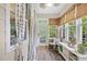 Inviting sunroom featuring tile flooring, bright windows with curtains, and comfortable seating at 1444 Thames Ct., Myrtle Beach, SC 29577