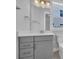 Bathroom showcasing vanity with storage, quartz countertops, and a mirror with modern lighting at 1533 Coastal Cove Ln, Calabash, NC 28467