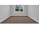 An empty bedroom featuring a single window providing natural light and neutral carpeting at 1533 Coastal Cove Ln, Calabash, NC 28467