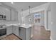 The spacious kitchen features gray cabinets, stainless appliances and a breakfast bar at 1533 Coastal Cove Ln, Calabash, NC 28467
