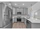 Well-equipped kitchen featuring stainless steel appliances and a breakfast bar area at 1533 Coastal Cove Ln, Calabash, NC 28467